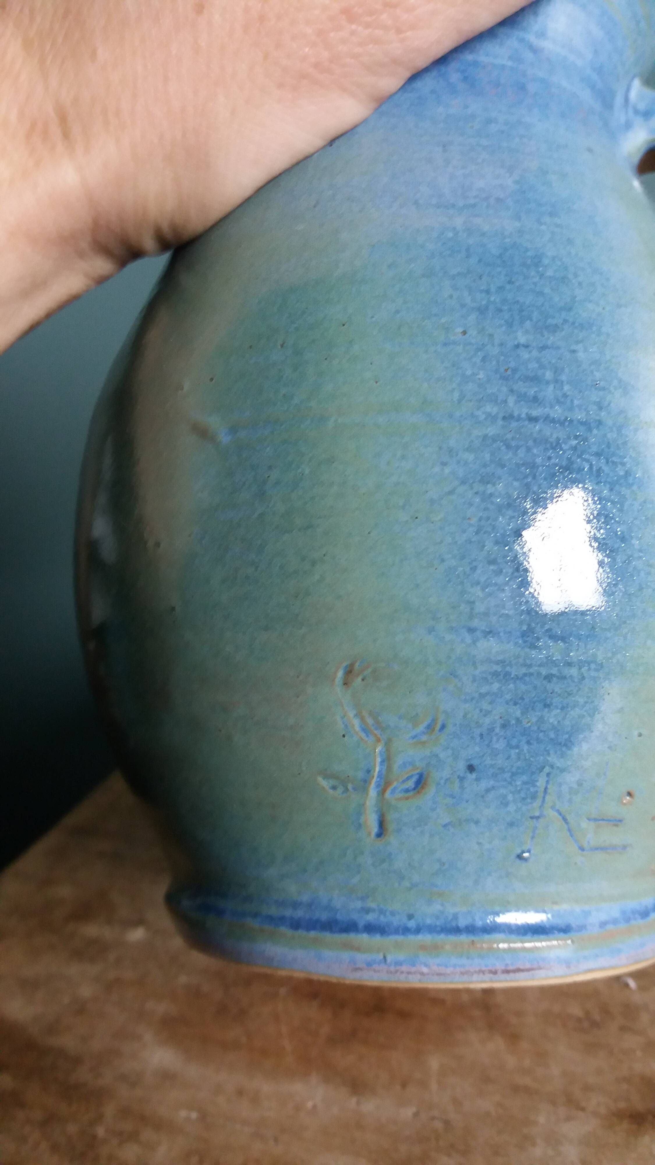 Enamel pitcher in pastel blue and green, signed