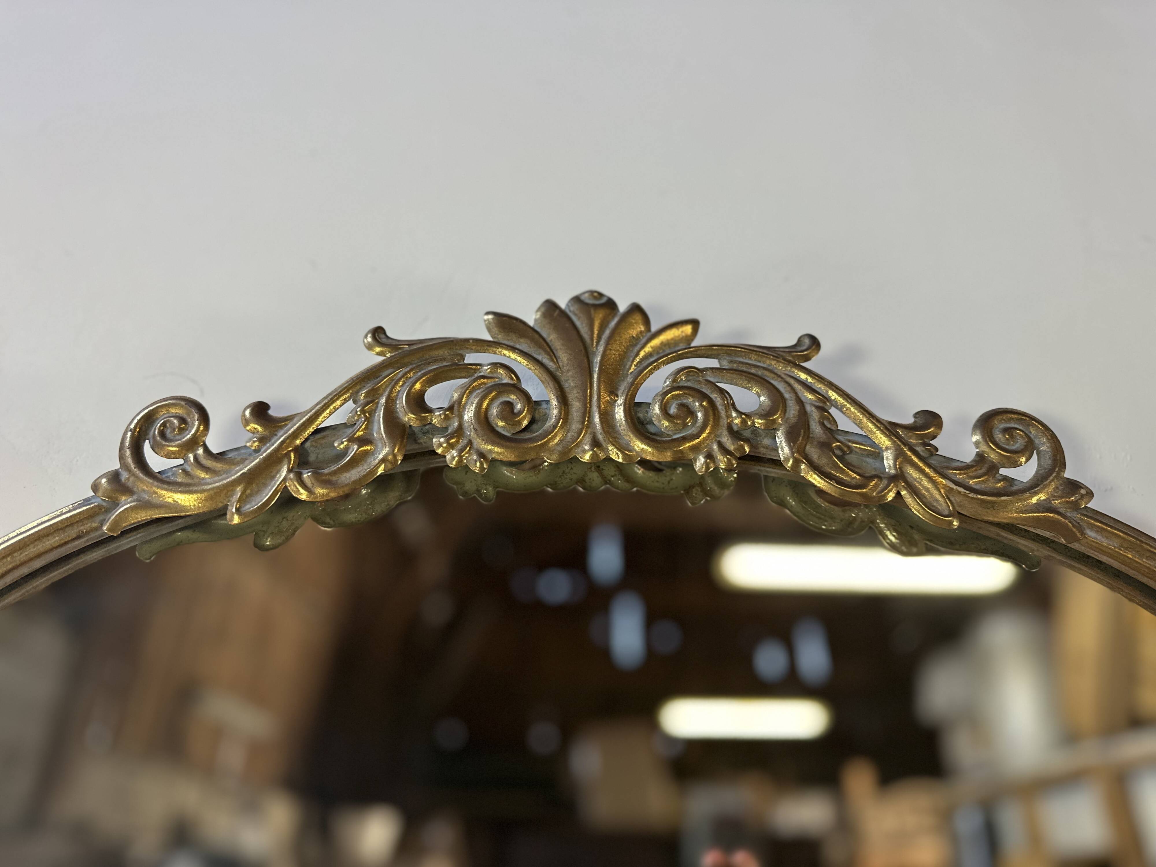 Golden metal pediment mirror from the 2000s.