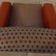 Retro vintage rockabilly armchair in orange faux leather and vintage fabrics