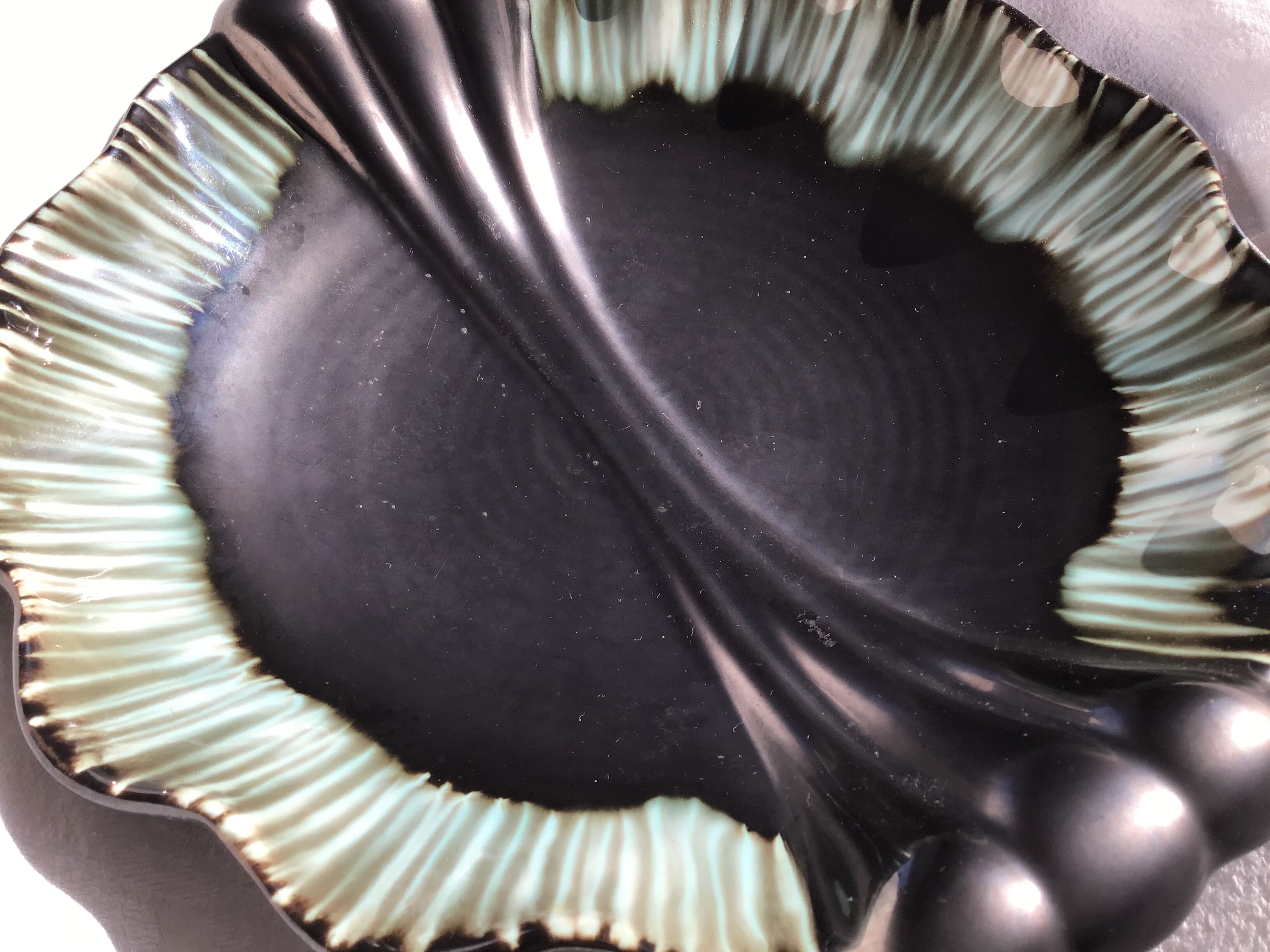 Undulating black iridescent ceramic cut