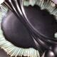 Undulating black iridescent ceramic cut