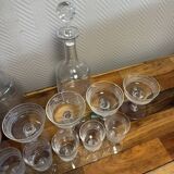 Engraved crystal service including 12 glasses and 2 carafes