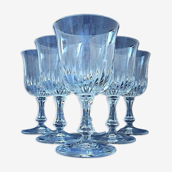 Suite of six white wine glasses on colorless glass stand