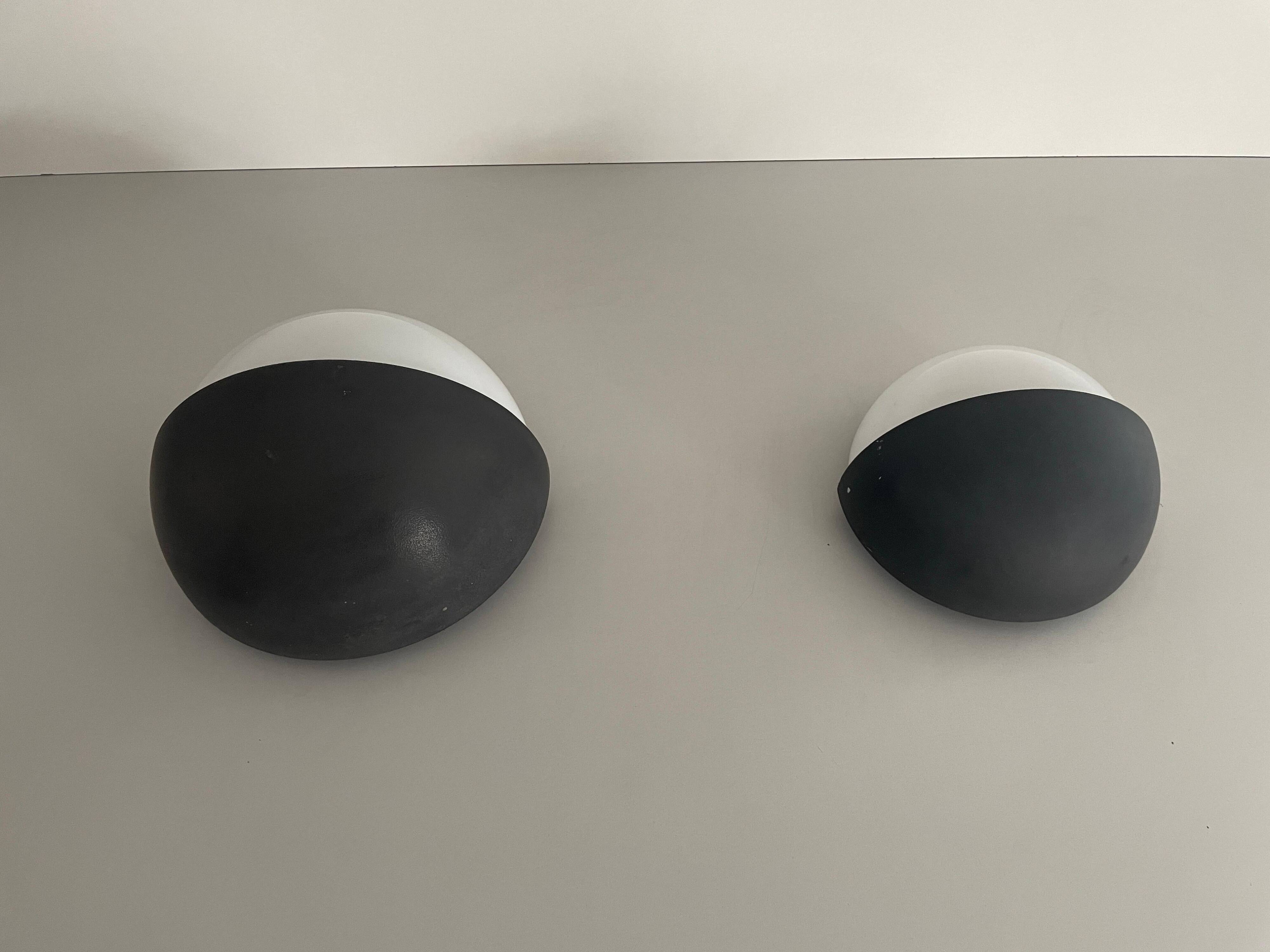 Round black metal wall lights, small and large set, by Bega, 1970s, Germany.