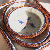 Set of 3 porcelain dishes with floral decorations, with wicker supports.