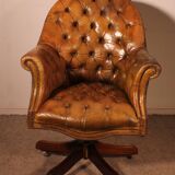Office chair known as a presidential chair in mahogany and cognac leather.