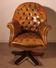 Office chair known as a presidential chair in mahogany and cognac leather.
