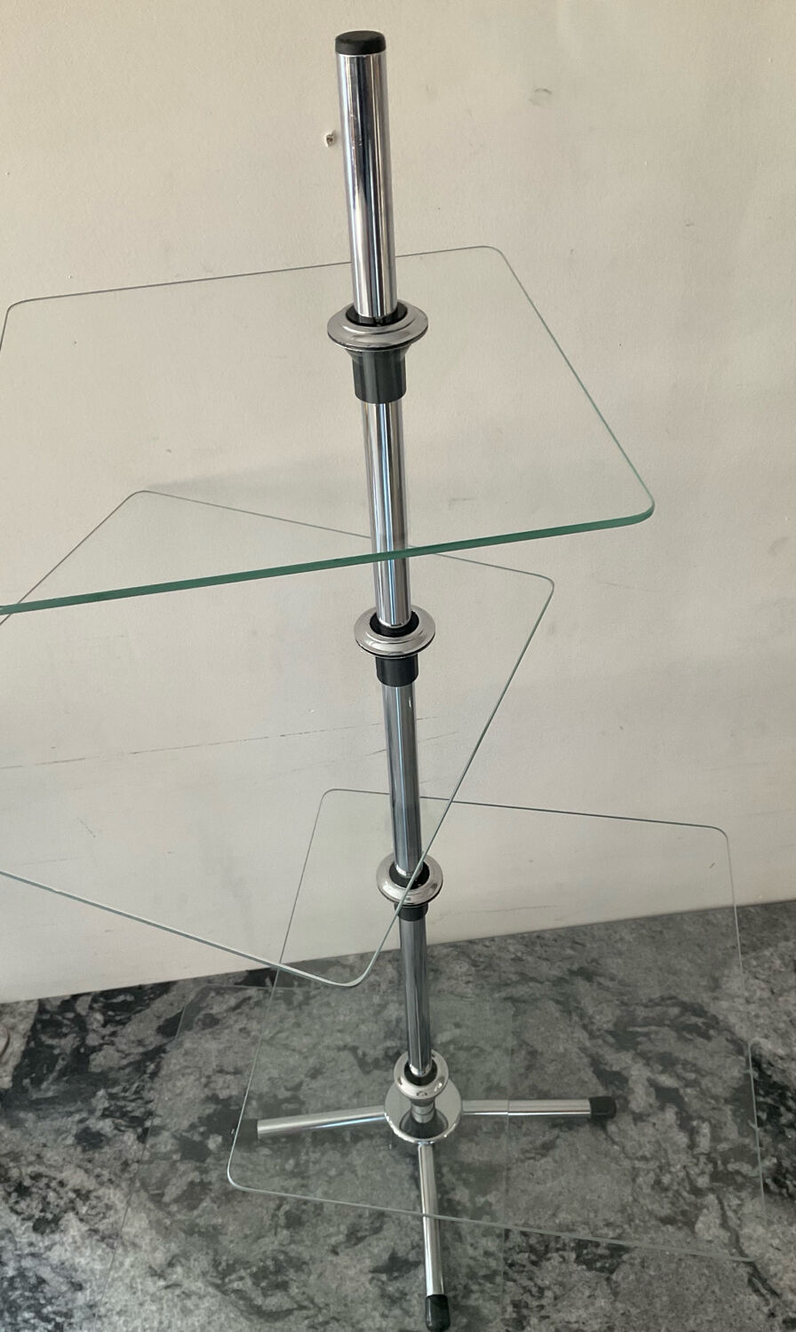 A pair of vintage side tables in glass and chrome metal.