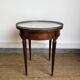 Louis XVI style bouillotte table in mahogany, white marble, and brass.