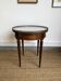 Louis XVI style bouillotte table in mahogany, white marble, and brass.