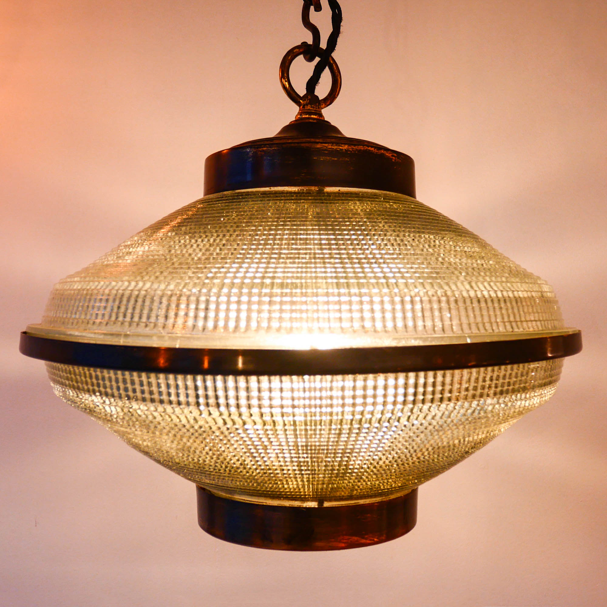 “Ellipse” pendant light in glass and patinated brass.