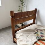 Brutalist style bed with chain and straw