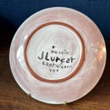 Terracotta plate, Jean Lurçat decorated with a character on a white background.