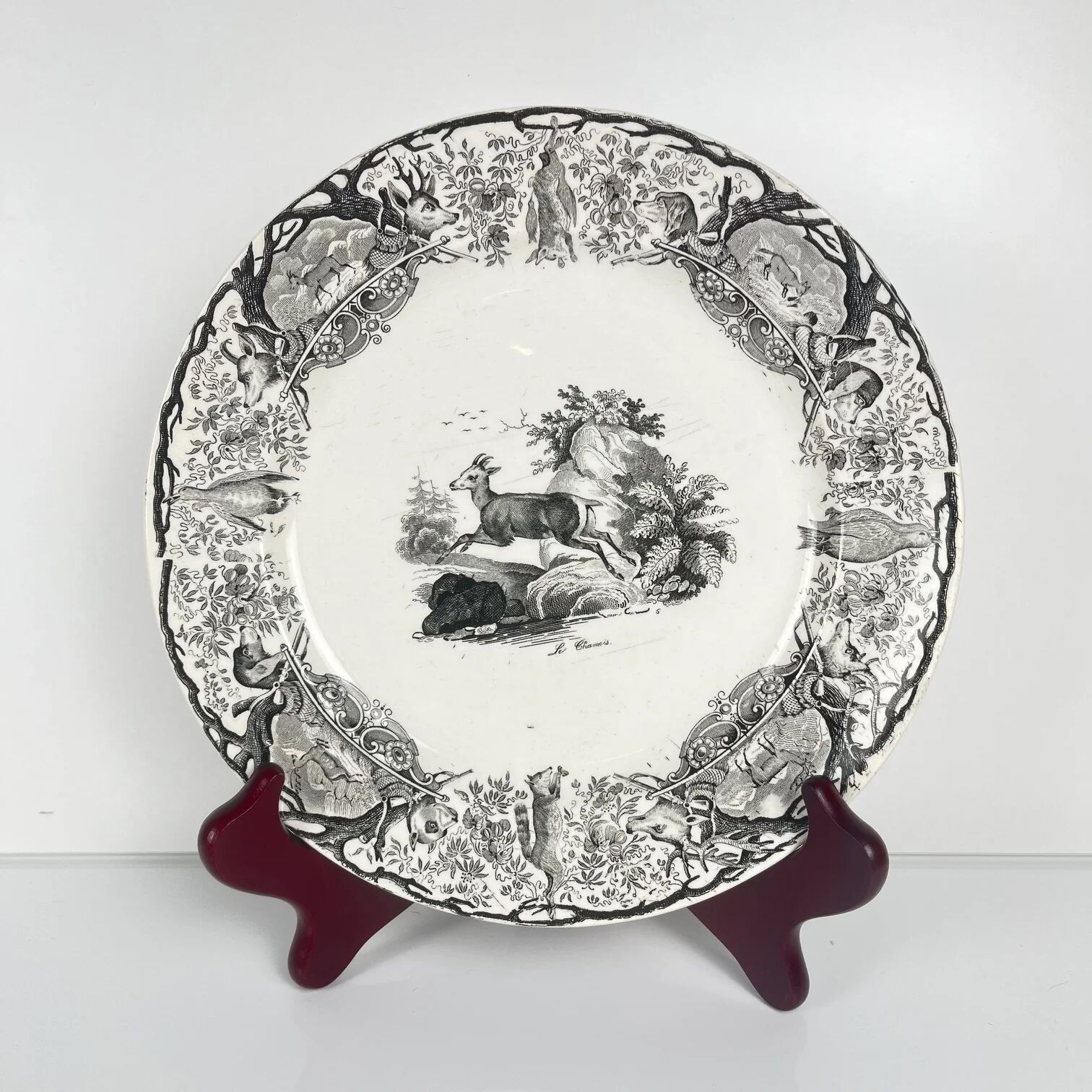 Set of three antique Sarreguemines U&C plates with hunting decoration from 1850 - 19th century black earthenware featuring a doe, chamois, and fox.