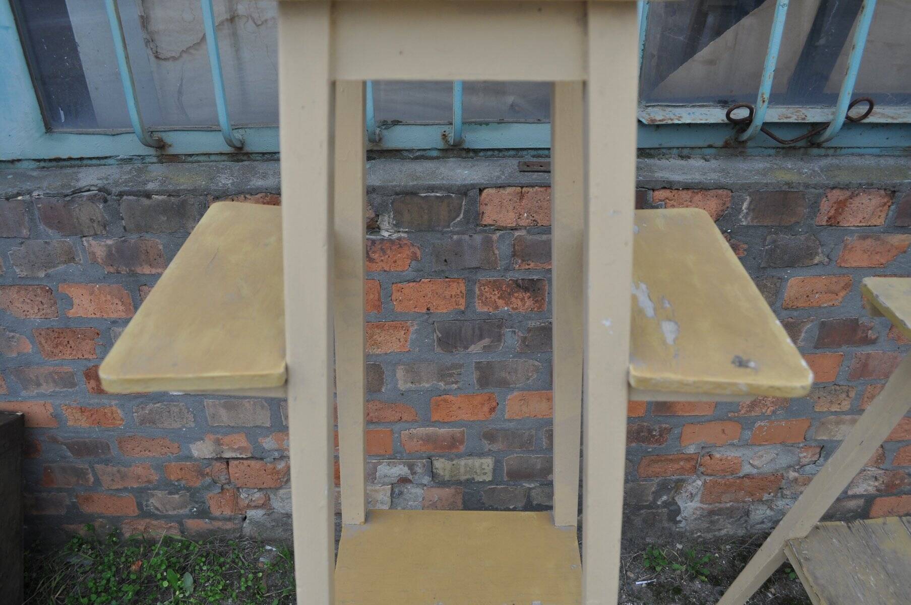 Vintage brown wooden plant stand from the 1940s — elegant footed support.
