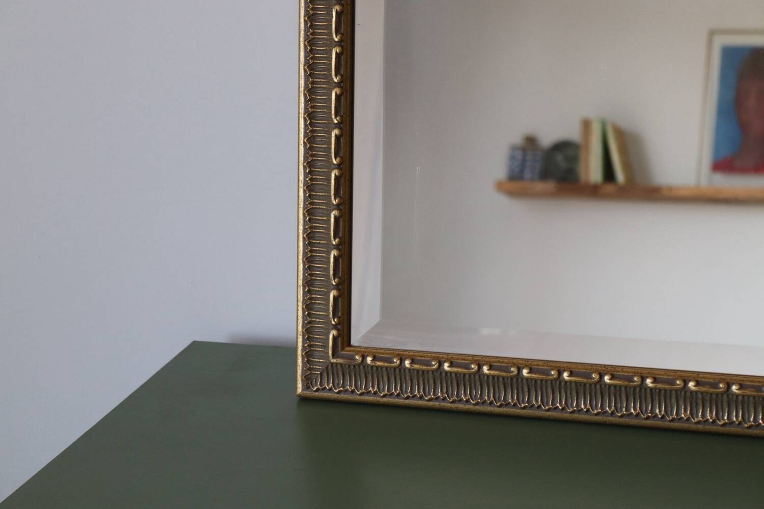 Rectangular gold mirror with moulded decoration.