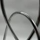 Chromed sculptural art object, abstract modernist shape in metal, contemporary design accent, brutalist interior decoration.