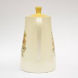 Old glazed ceramic coffee pot decorated with sunflowers