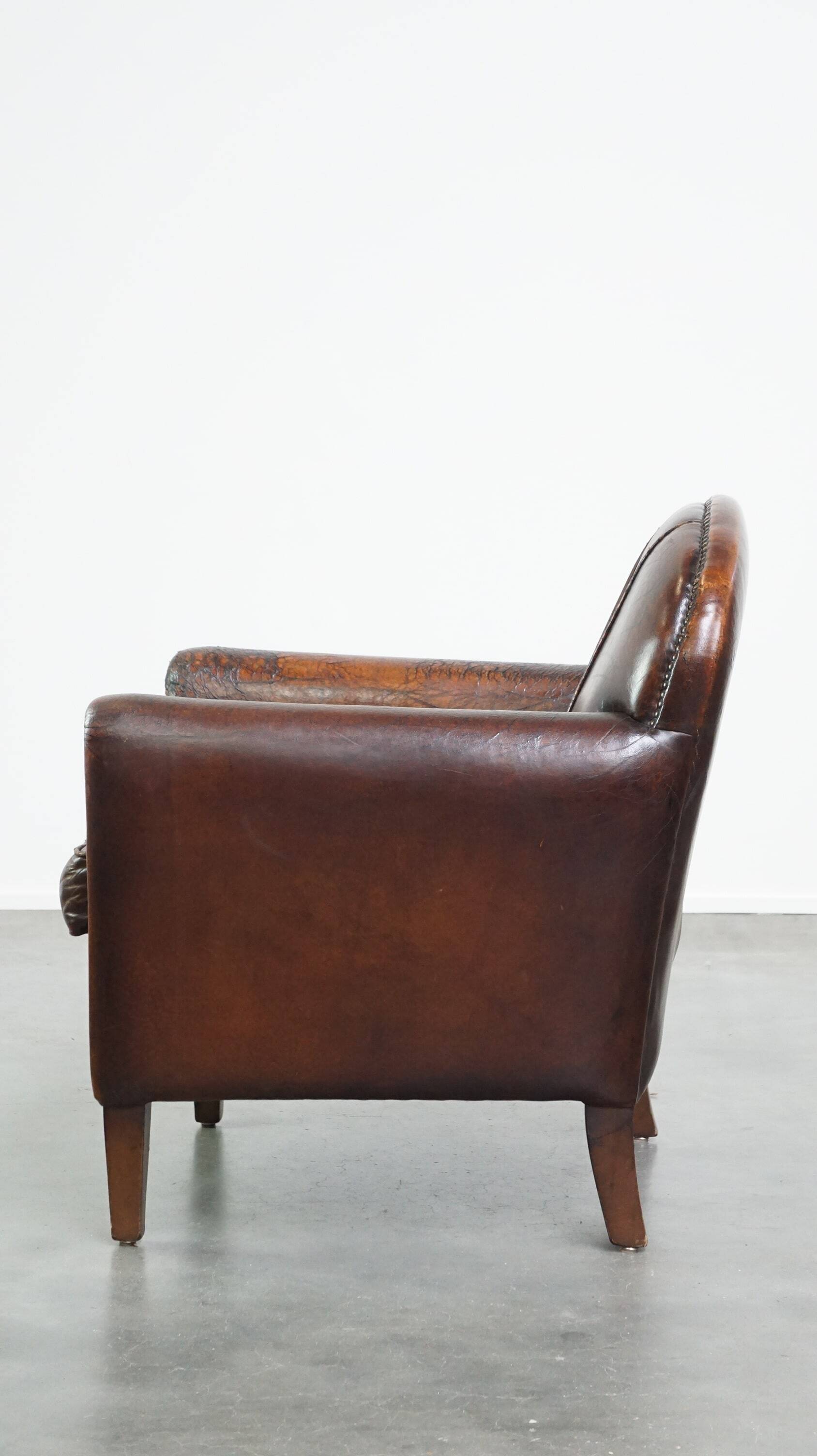 A vintage-style armchair with character, upholstered in beautifully patinated sheepskin.