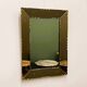 Striking French amber-coloured mirror with sculpted edge details, 1940s