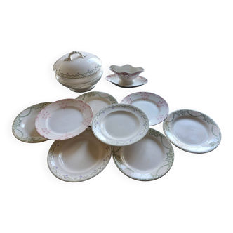 Mismatched plates accompanied by a soup tureen and a gravy boat