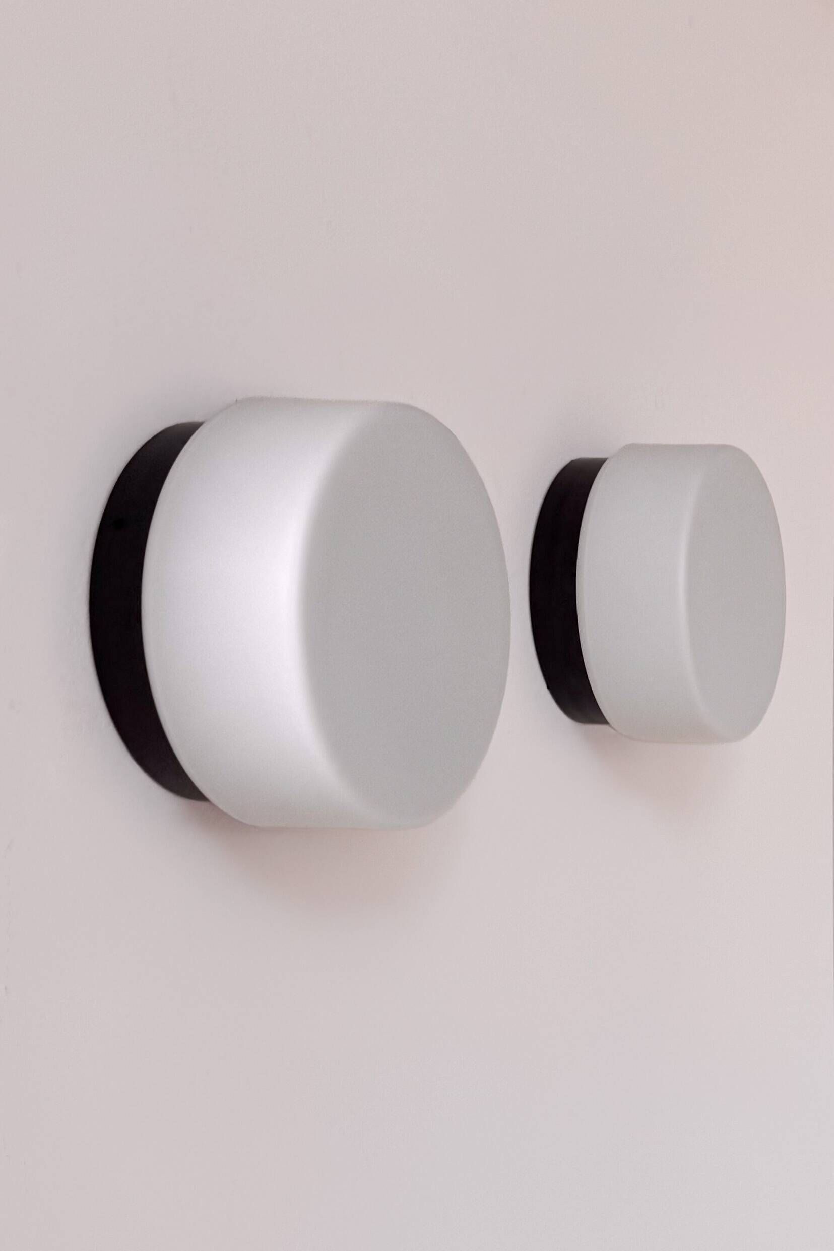 Pair of vintage wall lights in black Bakelite and frosted opal glass, France 1970.