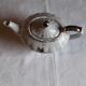 Musical teapot in white porcelain with floral decoration
