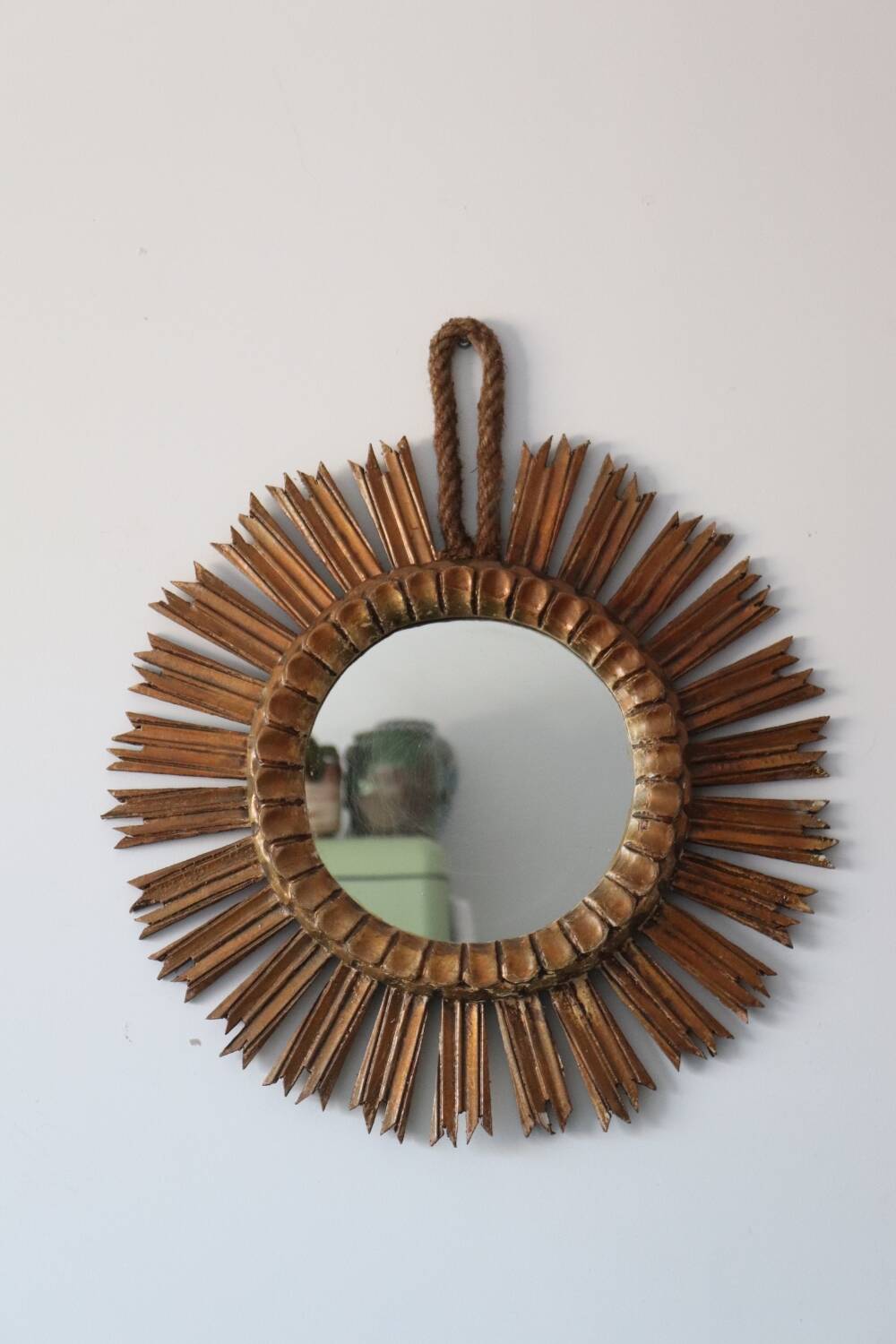 Old large sun mirror in gilded wood
