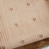 Vintage raspberry pattern earthenware and wood trivet