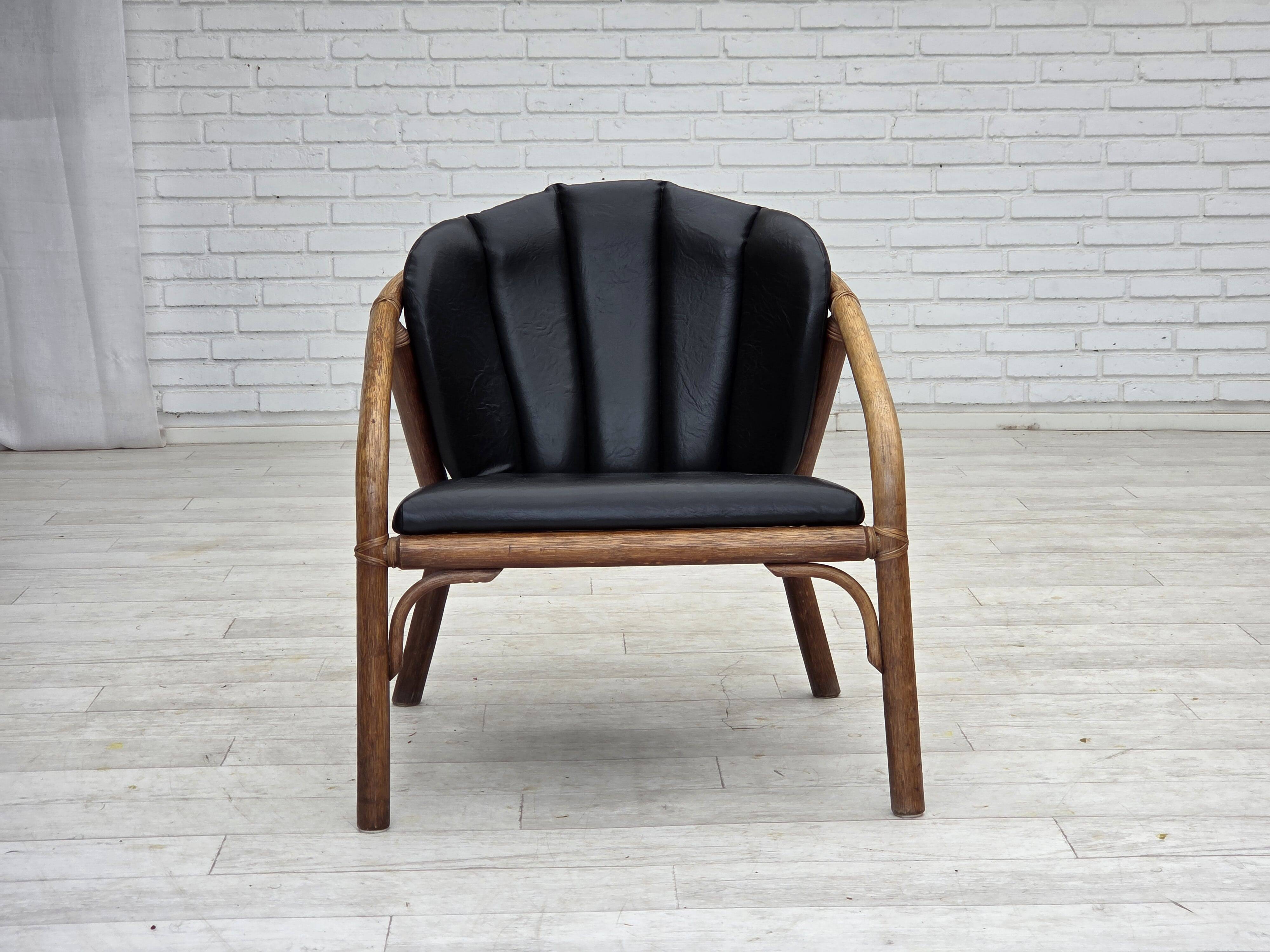 1970s, Danish armchair, rattan, black artificial leather.