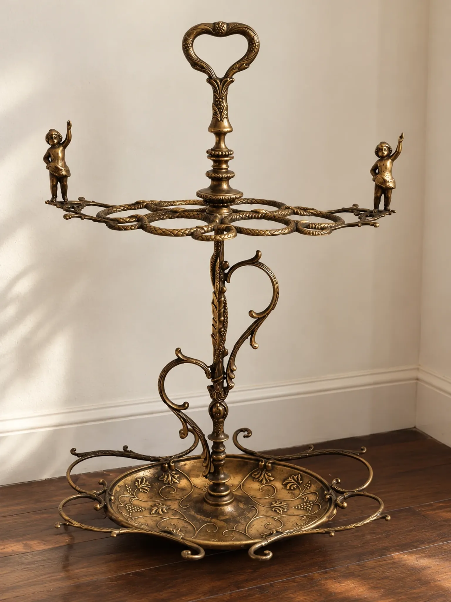 Italian brass umbrella stand, Art Nouveau style, with putti.