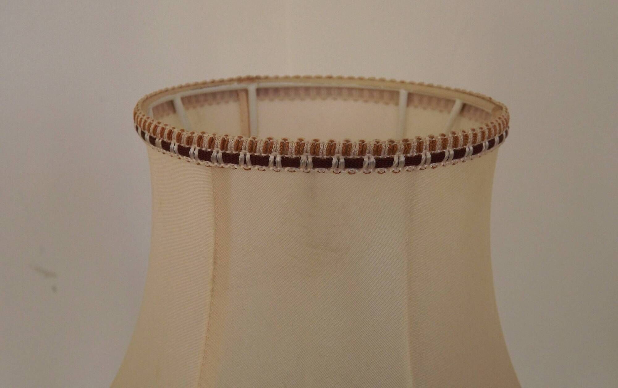 Mid-century French table lamp made of turned carved wood with a fringed shade.