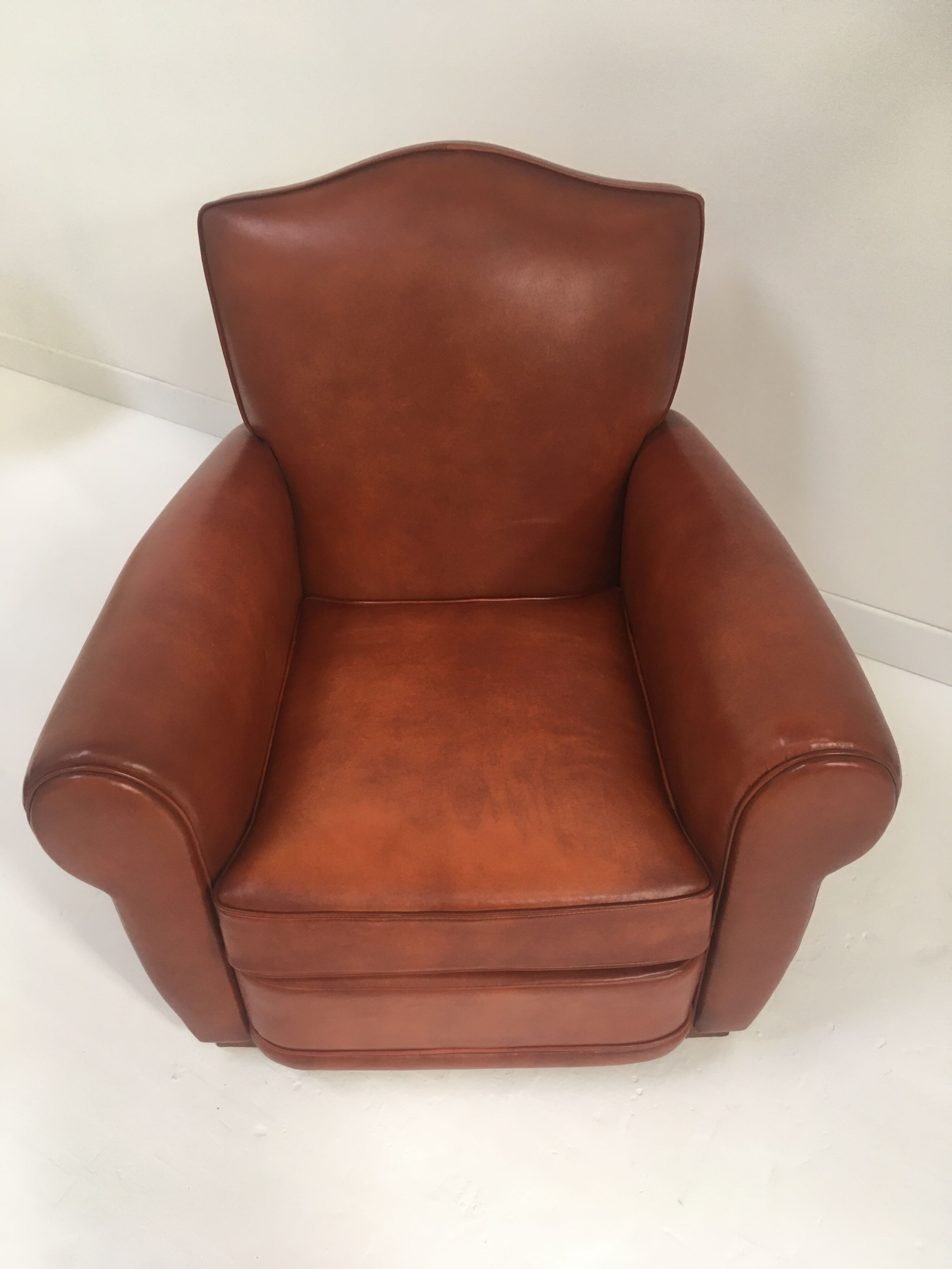 Large club chair in cognac leather