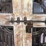 Chiseled teak door with openwork wrought iron panels