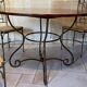 Table and four wrought iron and wood chairs.