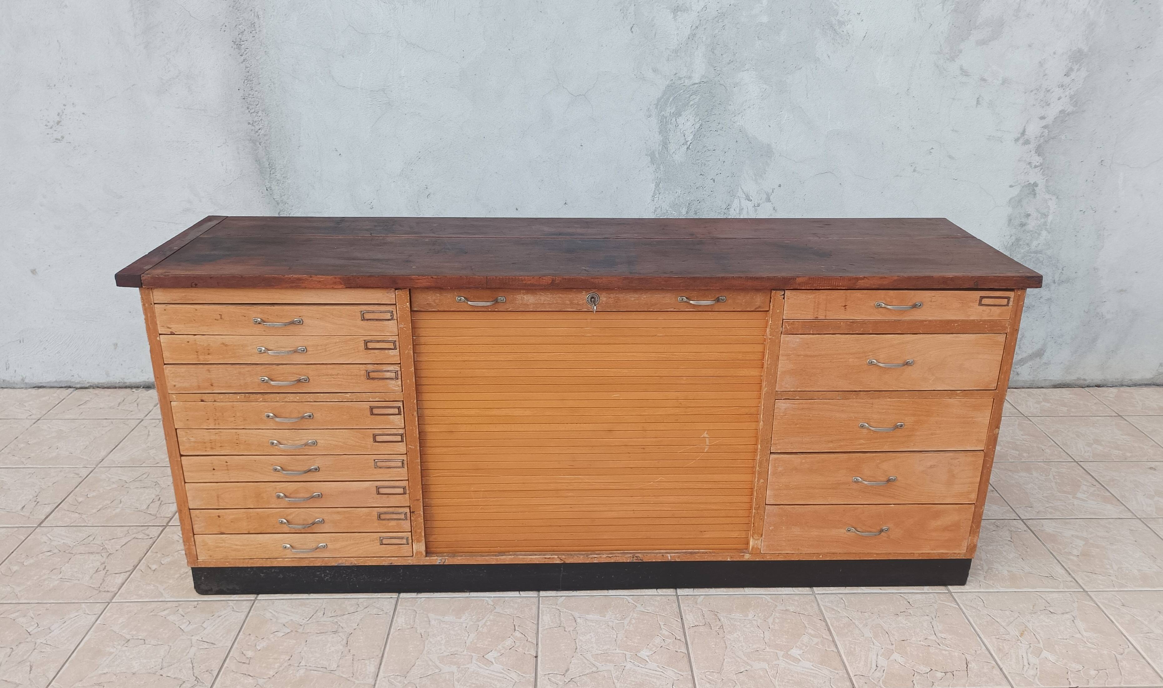 Workshop furniture with drawers and curtain in beech and walnut.