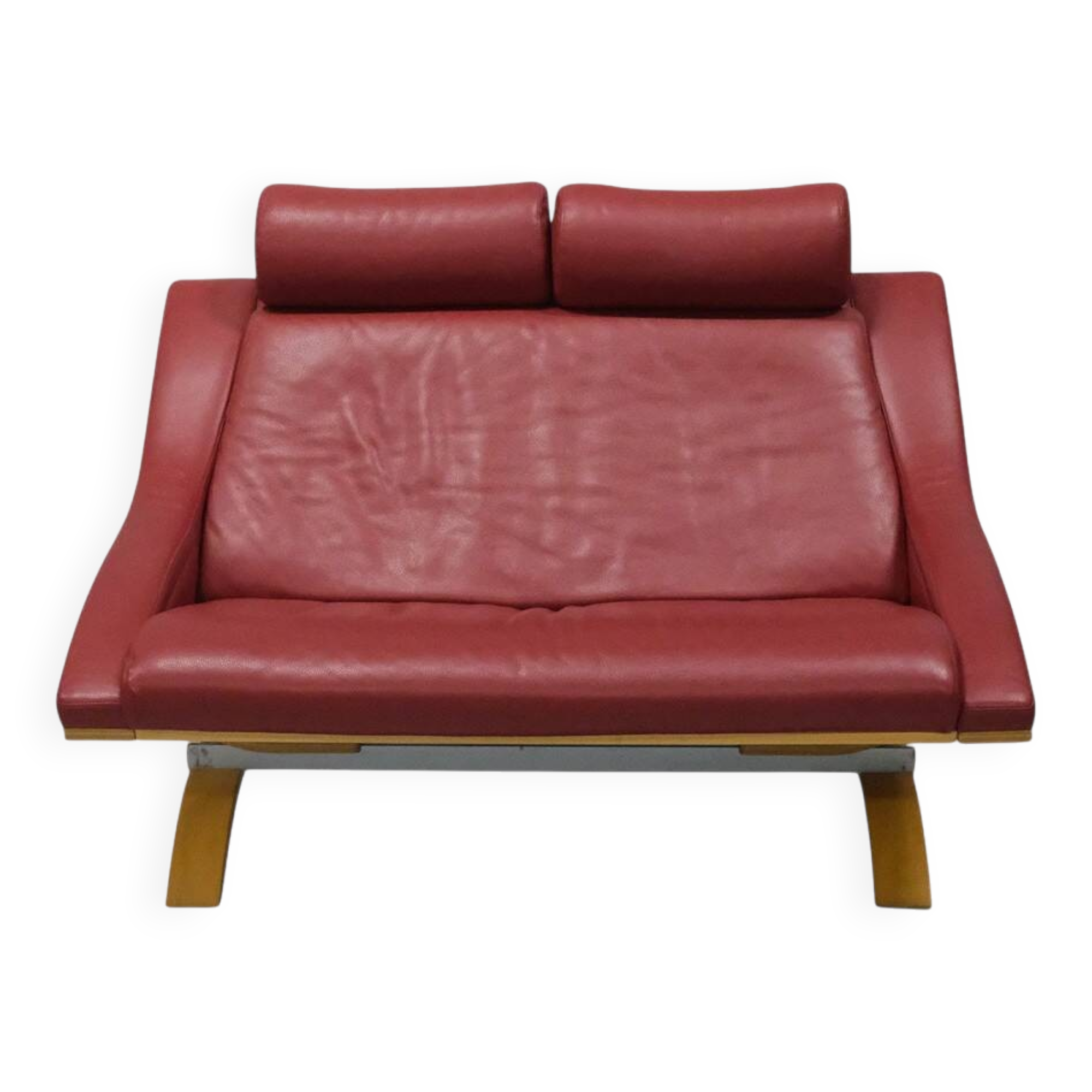 Two-seater red leather sofa by Roche Bobois on a bent beech base, France.