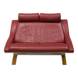 Two-seater red leather sofa by Roche Bobois on a bent beech base, France.