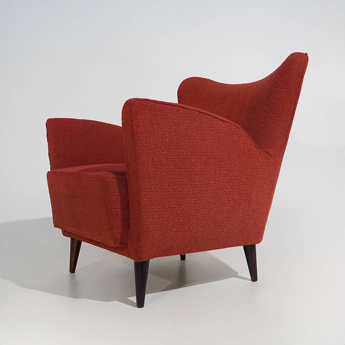 Pair of red armchairs with cone-shaped feet, 1950s