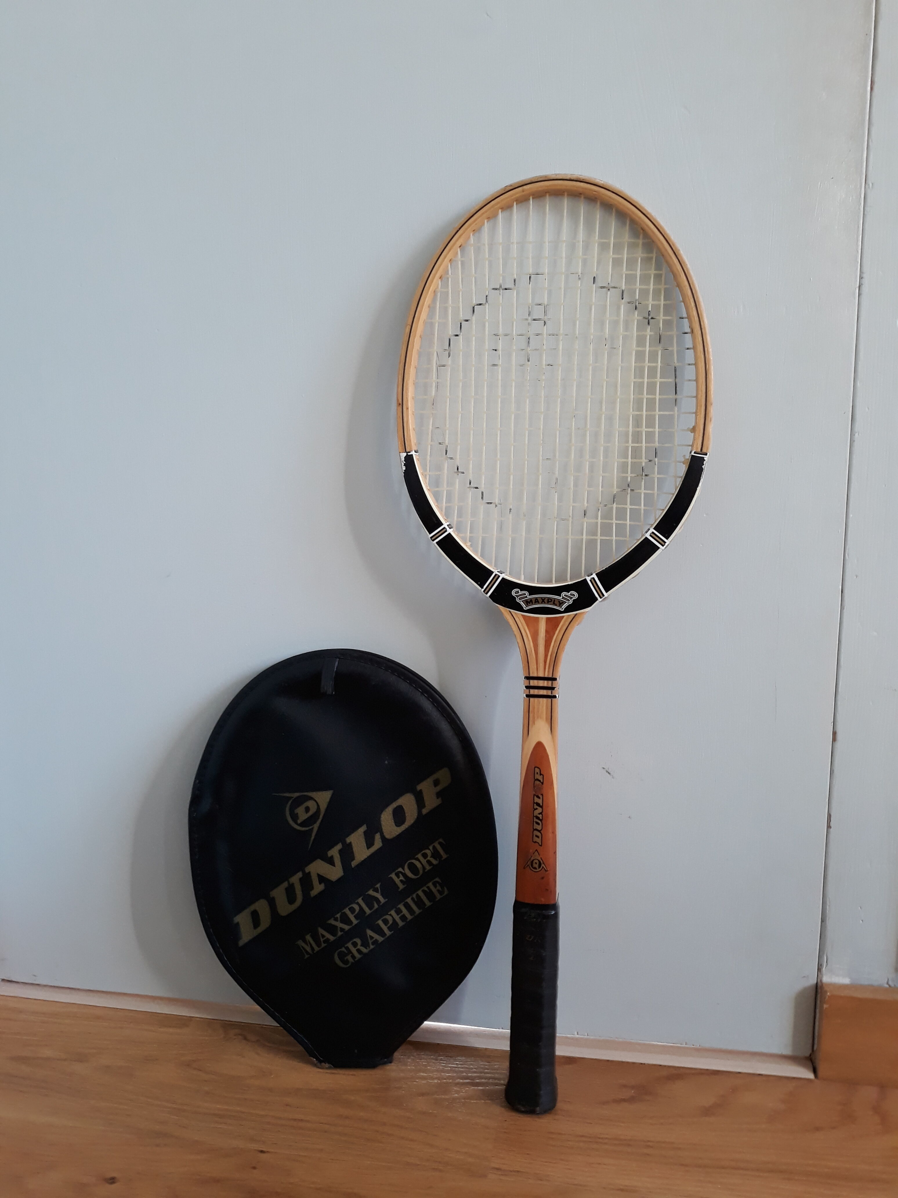 Wooden Dunlop tennis racket with its cover