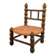 Low chair in beaded wood and straw