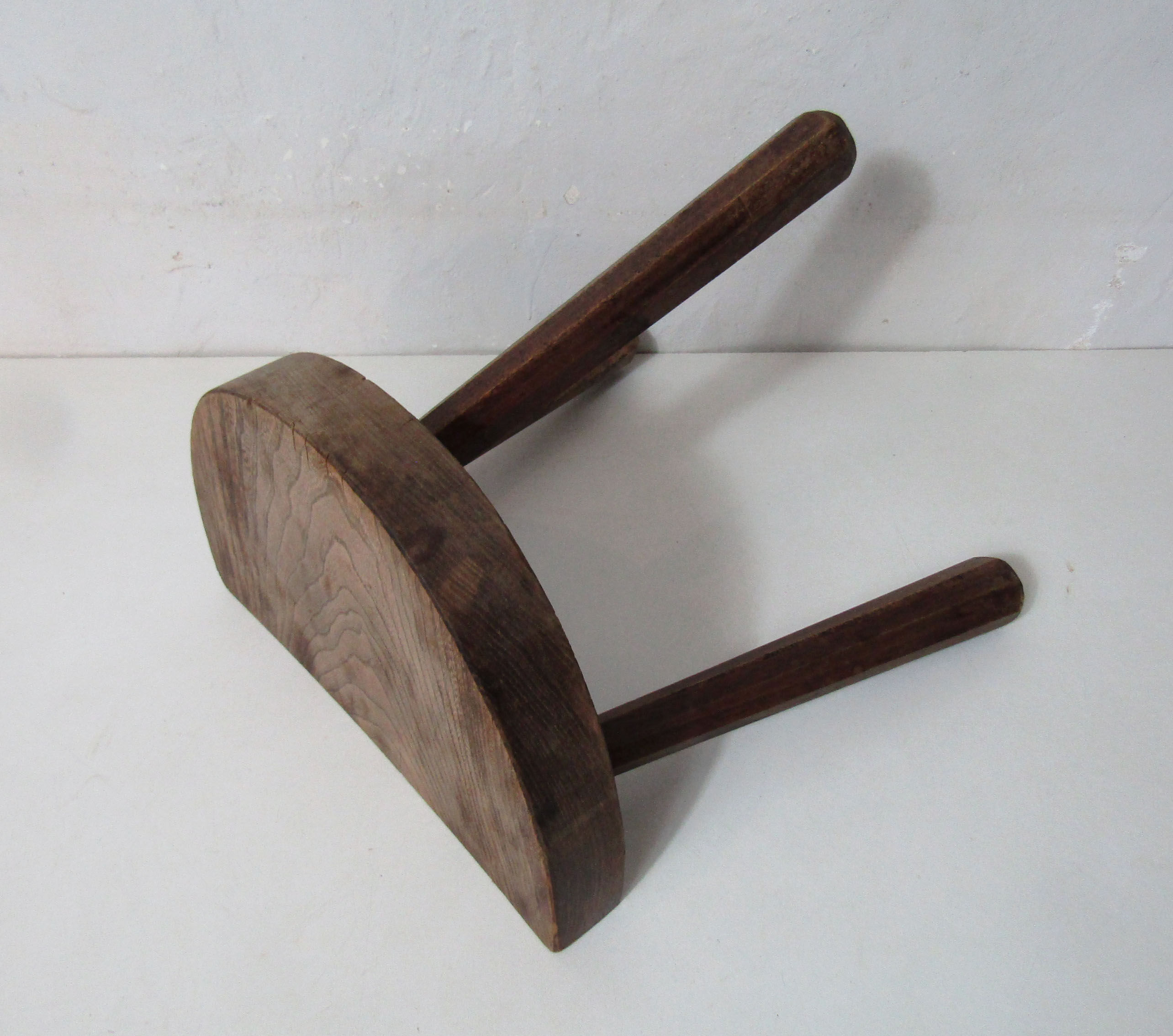 Old half-moon wooden tripod stool