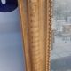Antique Louis Philippe mirror gilded with gold leaf.