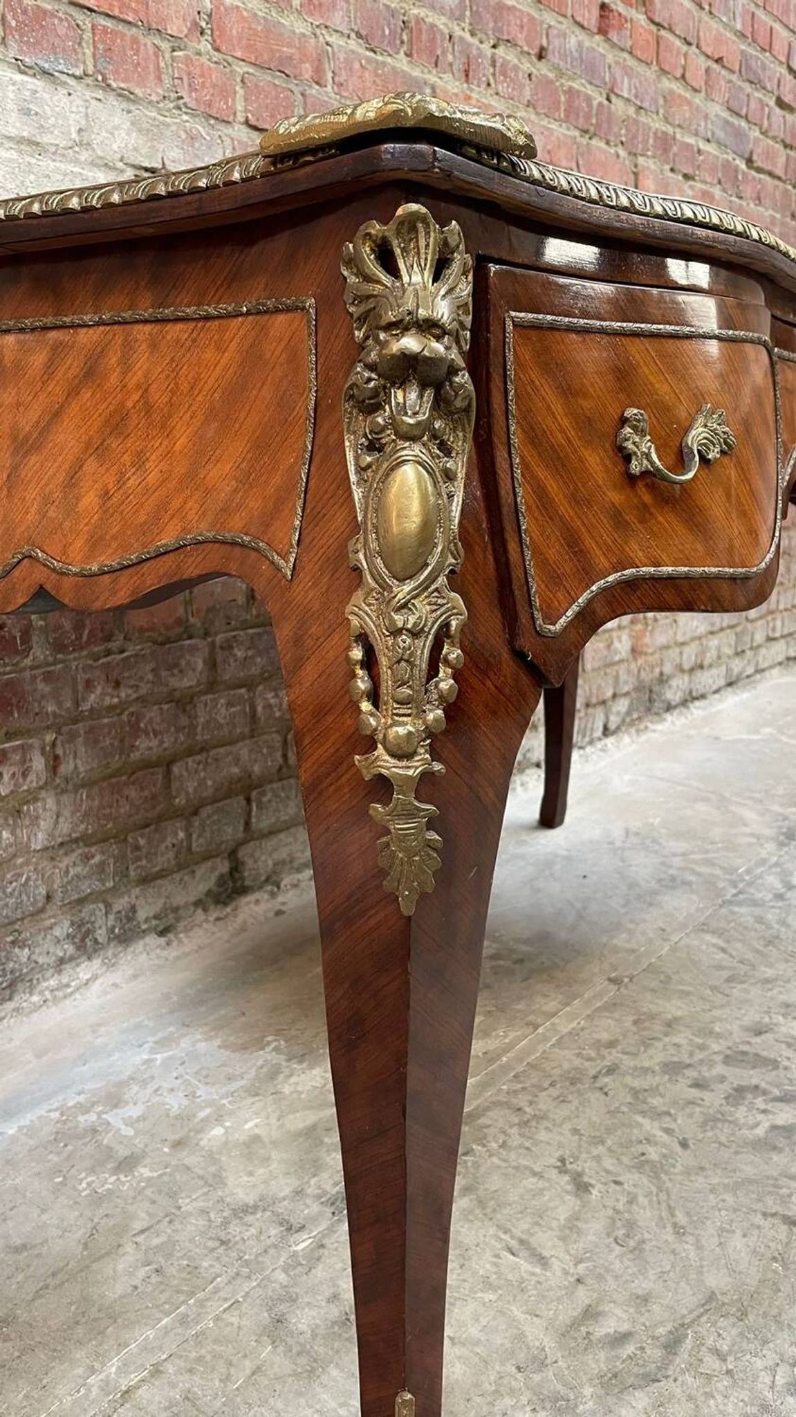 Antique French-style desk with green leather top and bronze mounts
