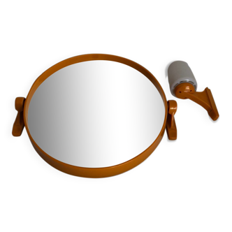Tilting orange plastic mirror with its matching wall light