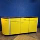 Vintage yellow sideboard, and black marble top.
