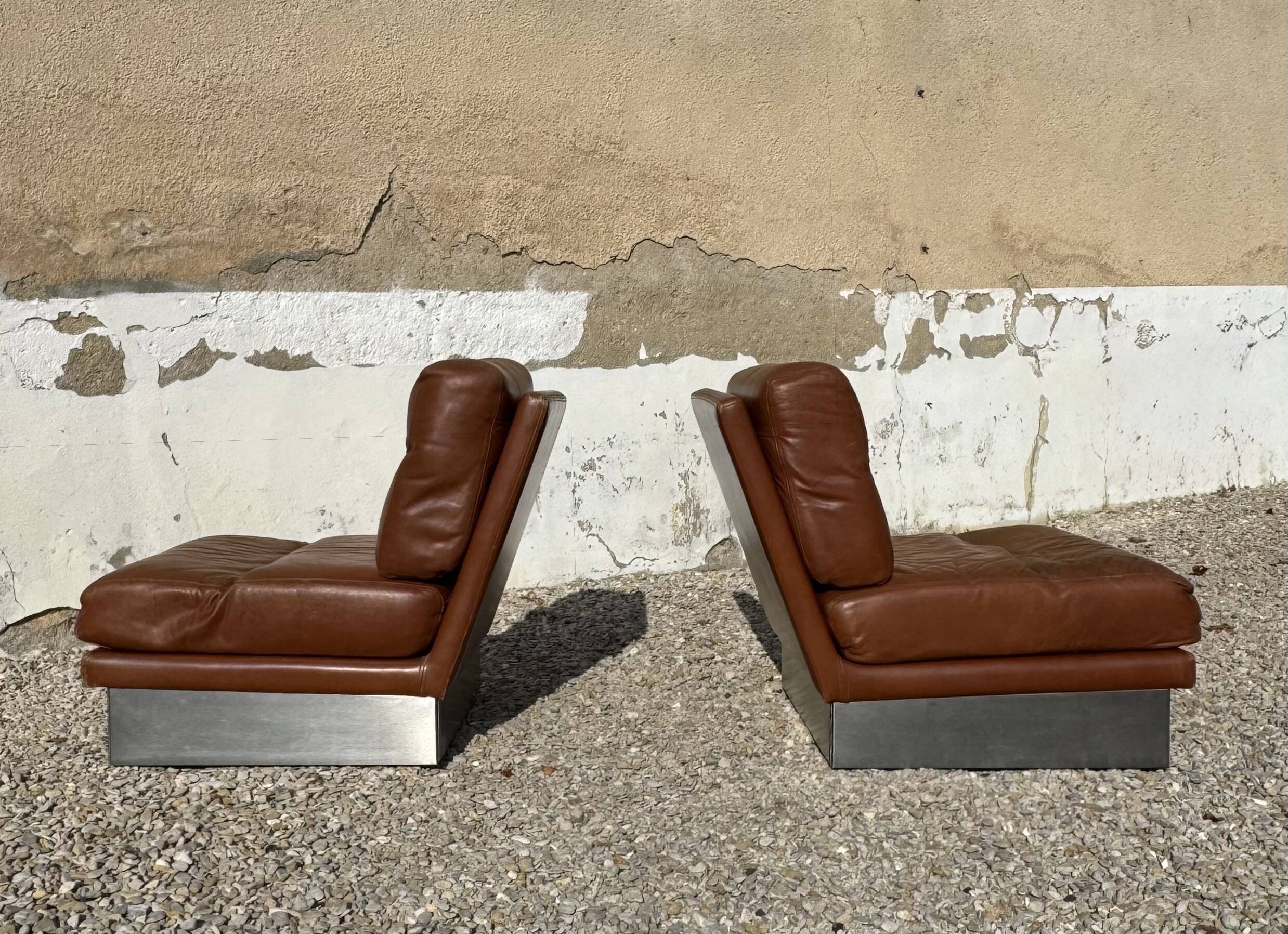 2 armchairs and 1 ottoman in brushed aluminium and brown leather, France, 1970.