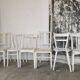Set of 6 mismatched white chairs
