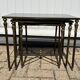 Nested tables in gilded brass in the style of Maison Charles.