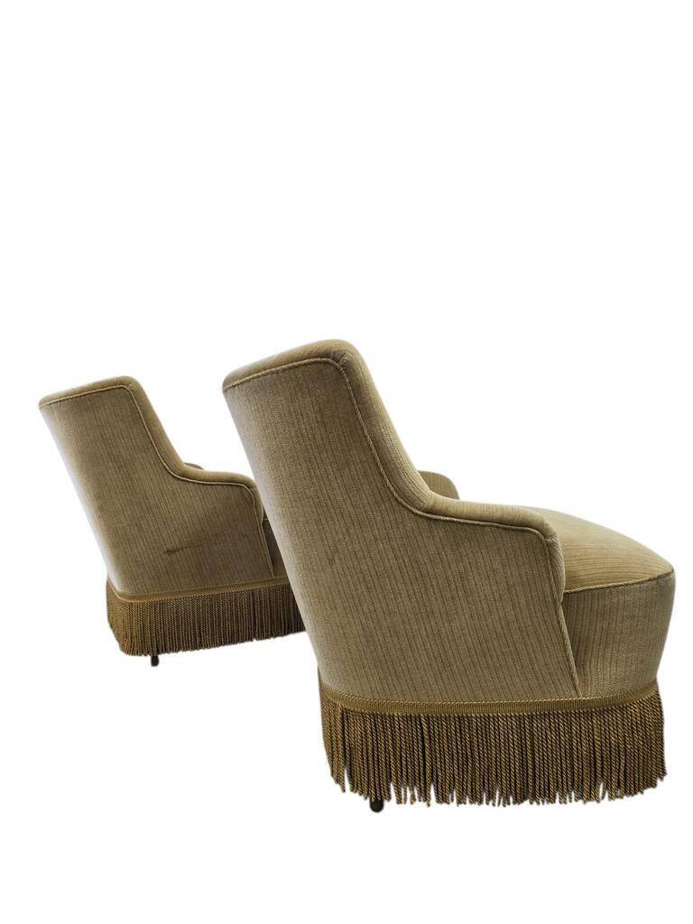 Set of 2 vintage 'gold' armchairs with fringes.